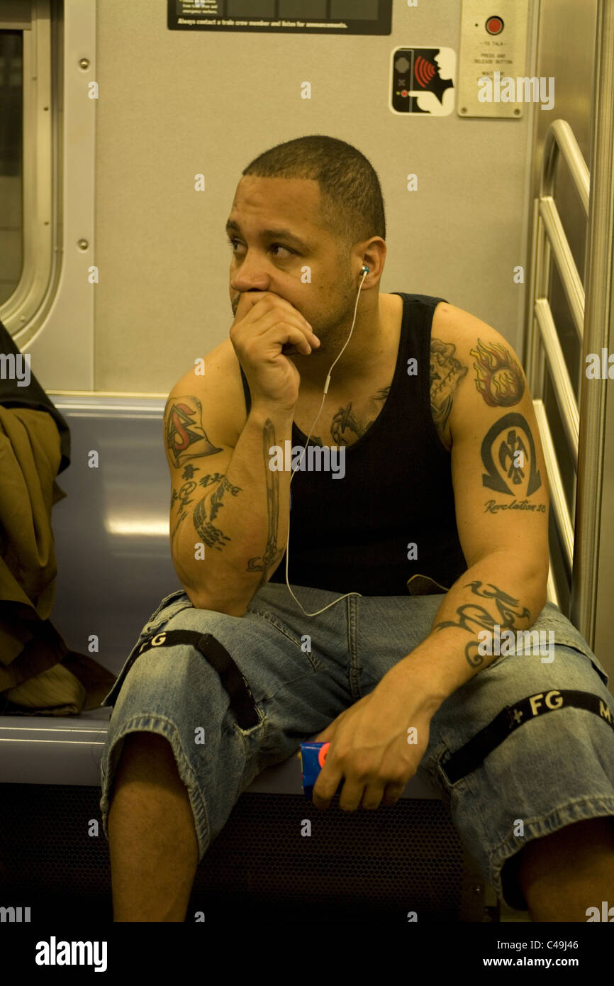 Subway rider with tattoos, New York City Stock Photo - Alamy