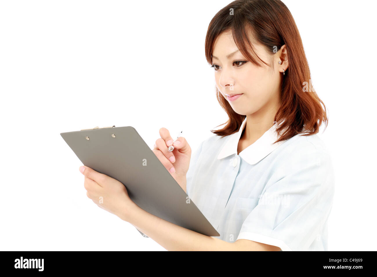 Young asian female nurse in uniform, holding a clipboard Stock Photo ...