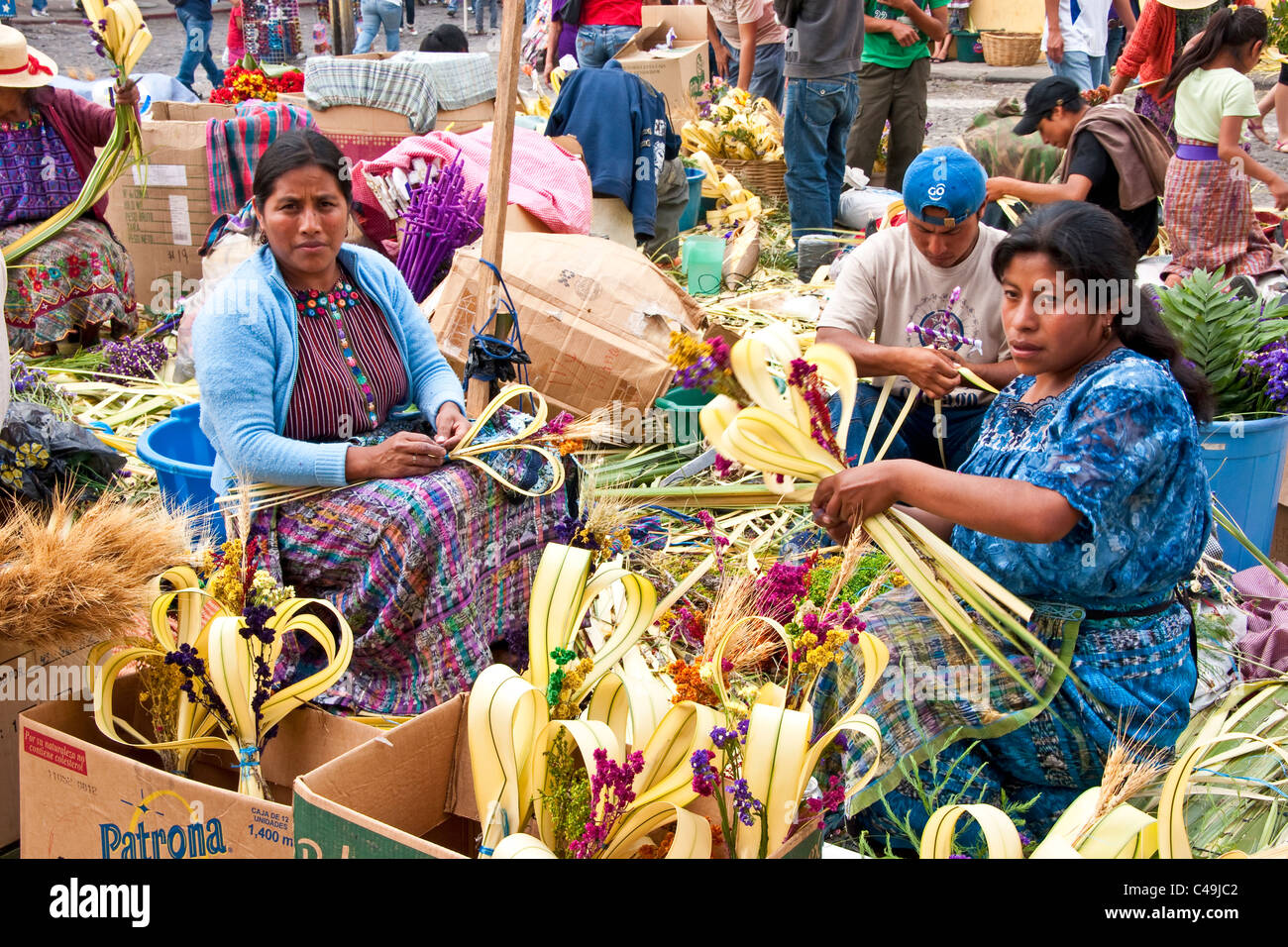 Mayan women hand-crafting palms in front of Iglesias La Merced church in Antigua to be sold for Holy Week (Semana Santa) Stock Photo