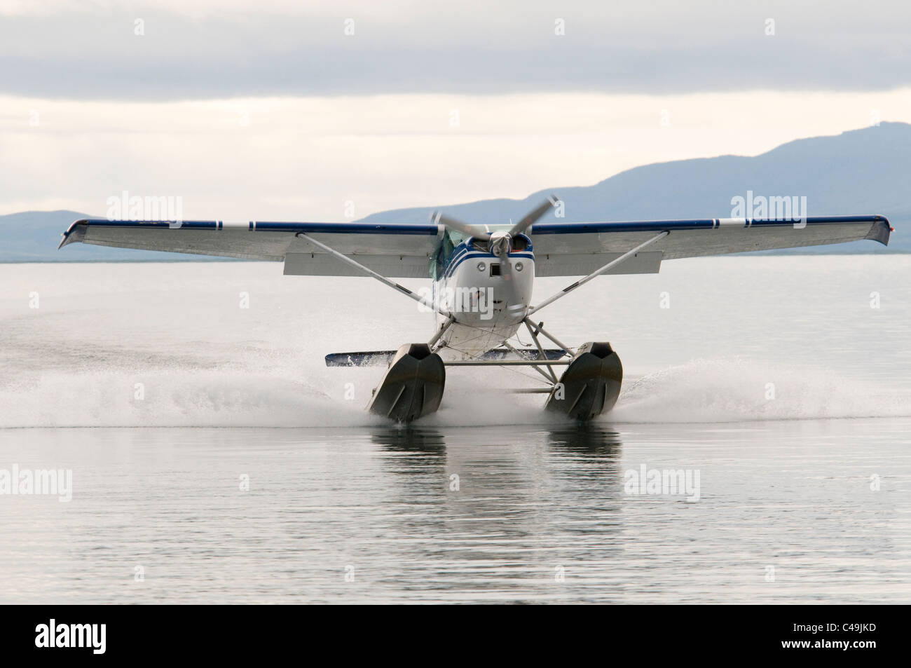 Cessna 182 float plane landing on Becharof Lake Alaska Stock Photo