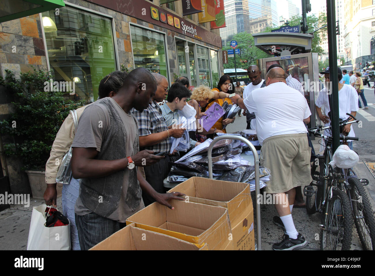 Shopping for bargains from a street vendor in Manhattan Stock Photo