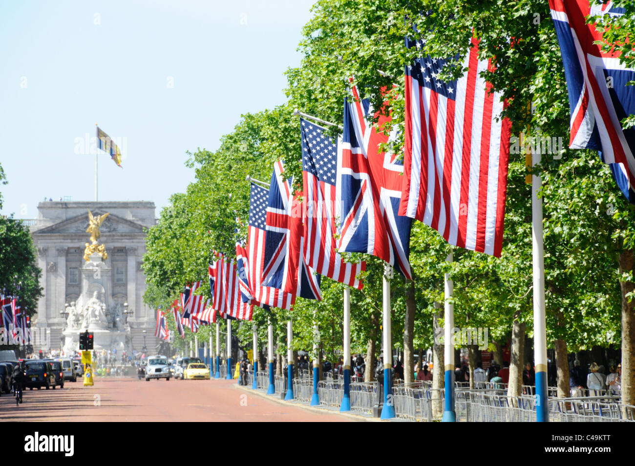 American flag & Union Jack line length of The Mall & Royal Standard above Buckingham Palace state presidential visit street scene London England UK Stock Photo