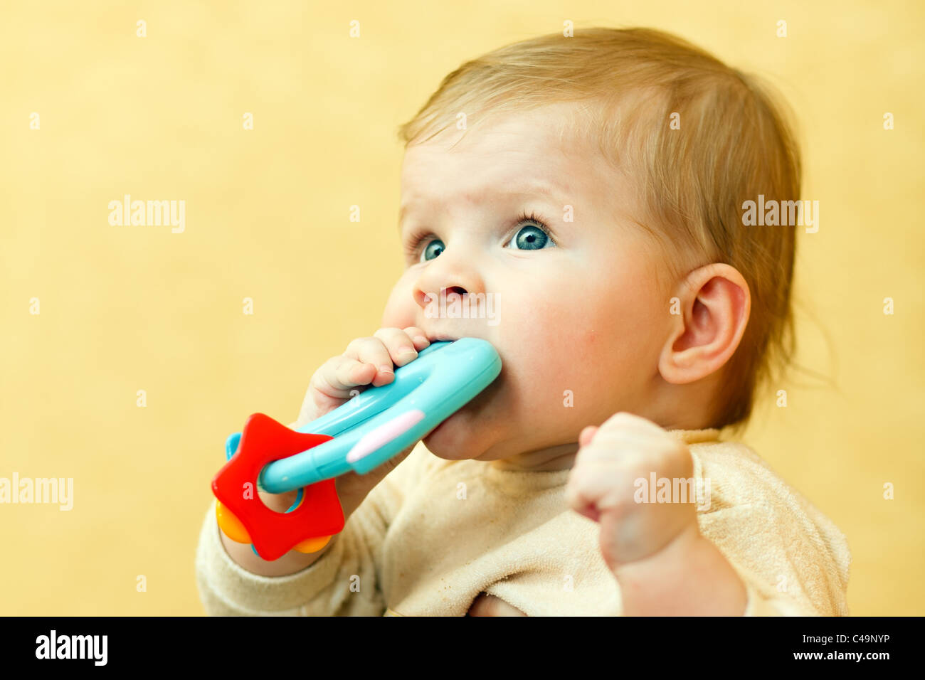 Small baby with a toy. Stock Photo