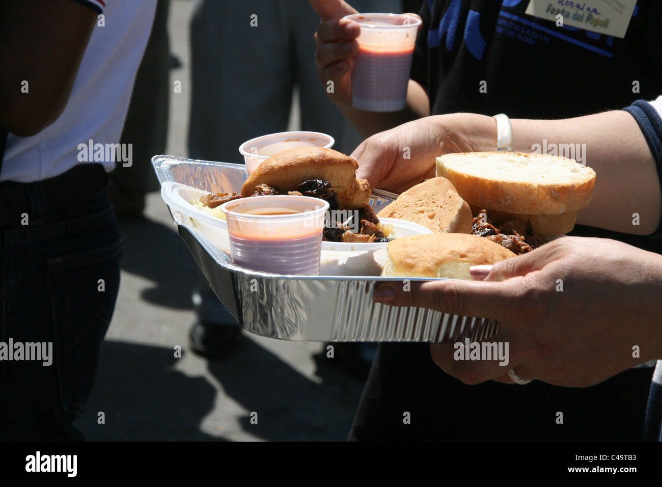 person carrying a tray full of food outdoors Stock Photo - Alamy
