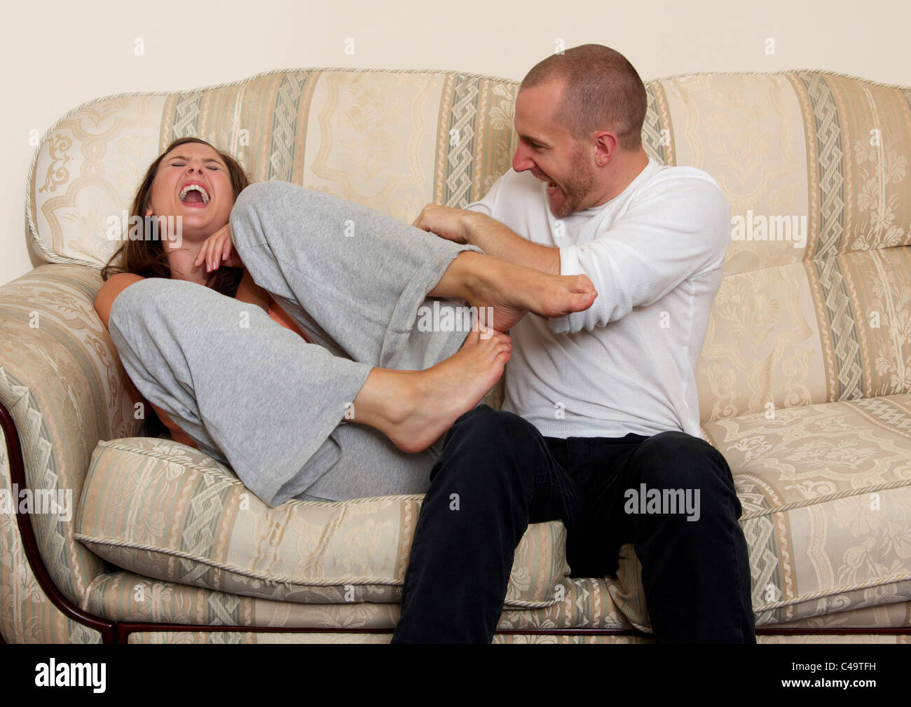 Man tickling woman Stock Photo