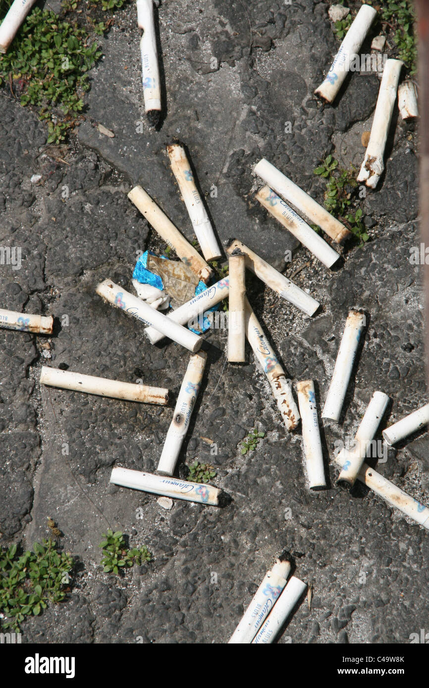 lots of cigarettes stubs on floor ground Stock Photo Alamy