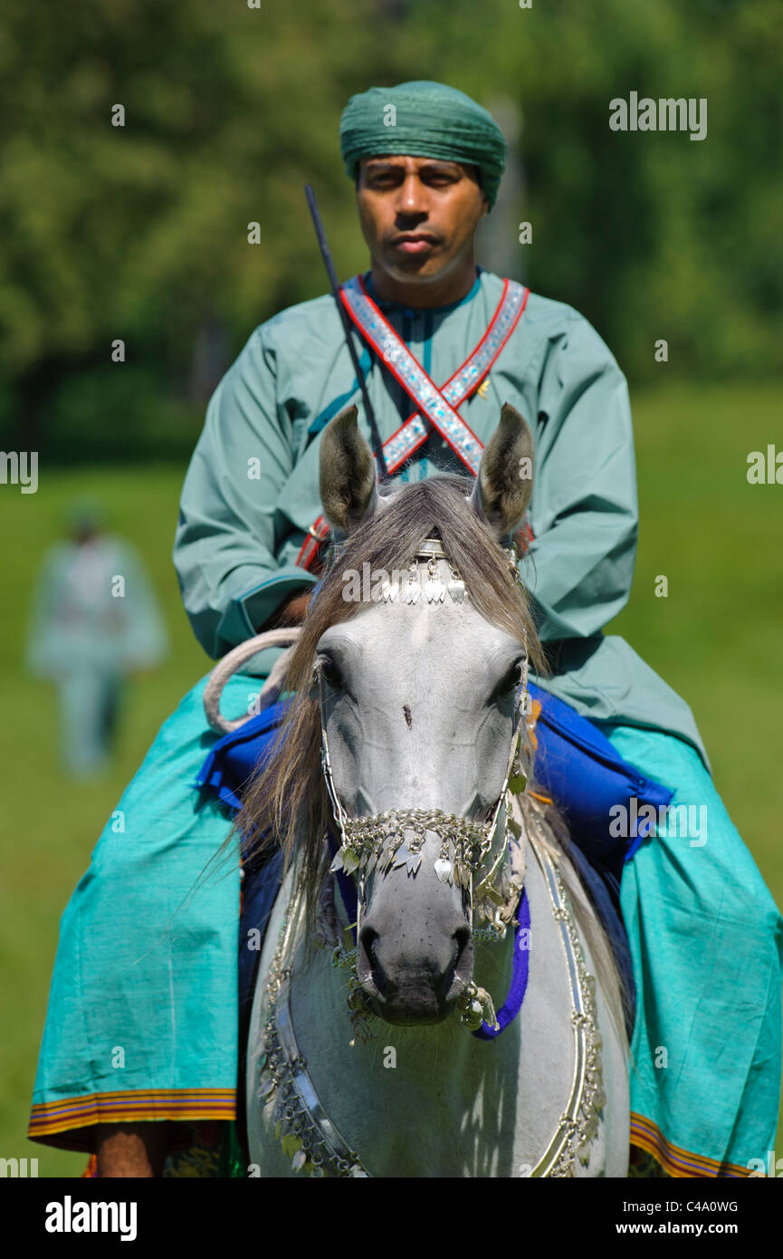 arabian Royal Cavalry of Oman in original costume on arabic horse while a public show performance in Munich, Germany Stock Photo