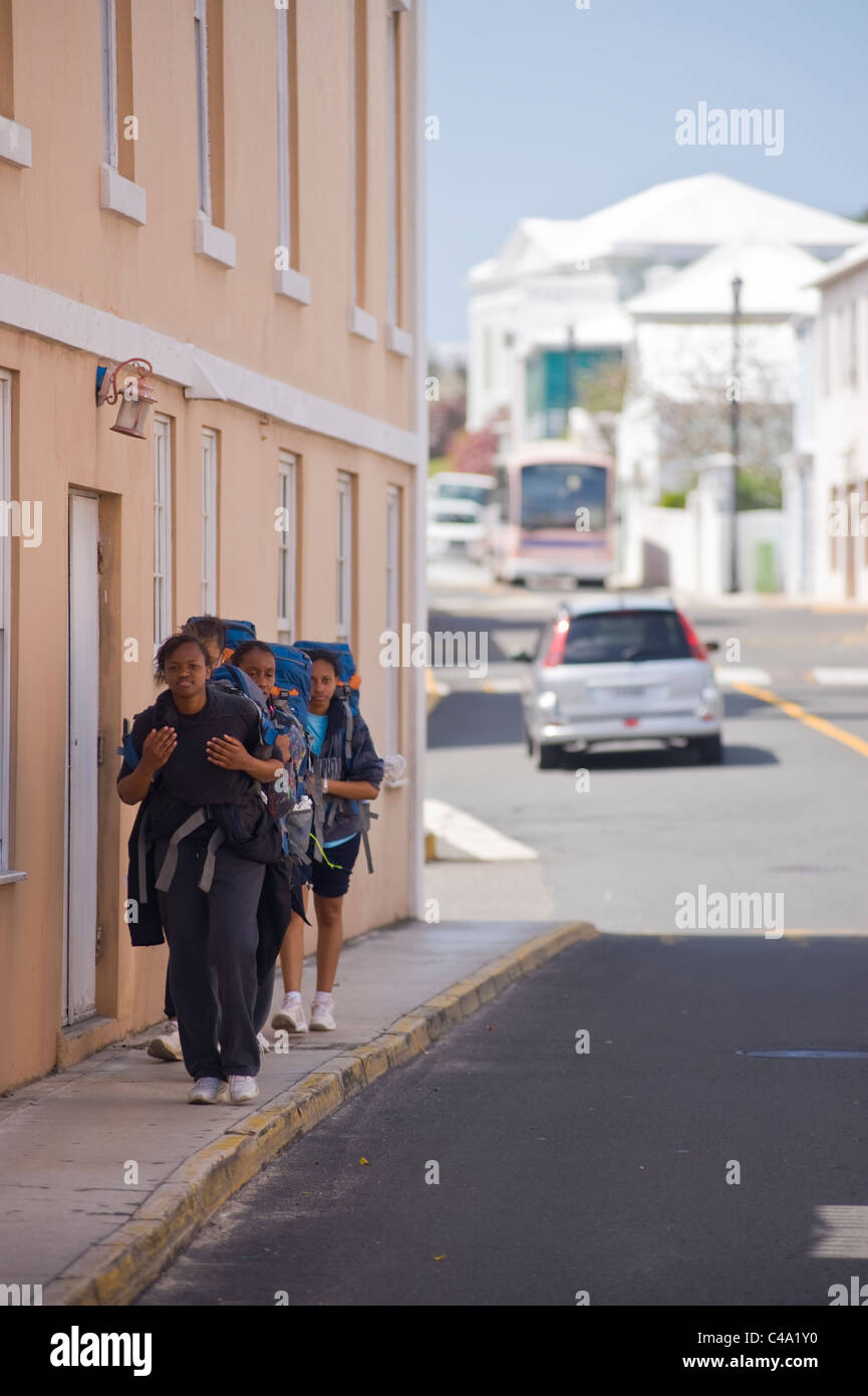 School children hiking through the streets of St. George, Bermuda. Stock Photo