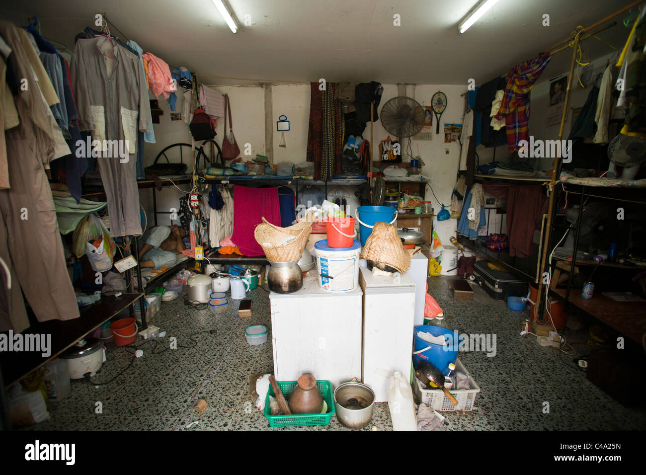 A foreign worker Inside a room in a dormitory for foreign workers in Singapore Stock Photo