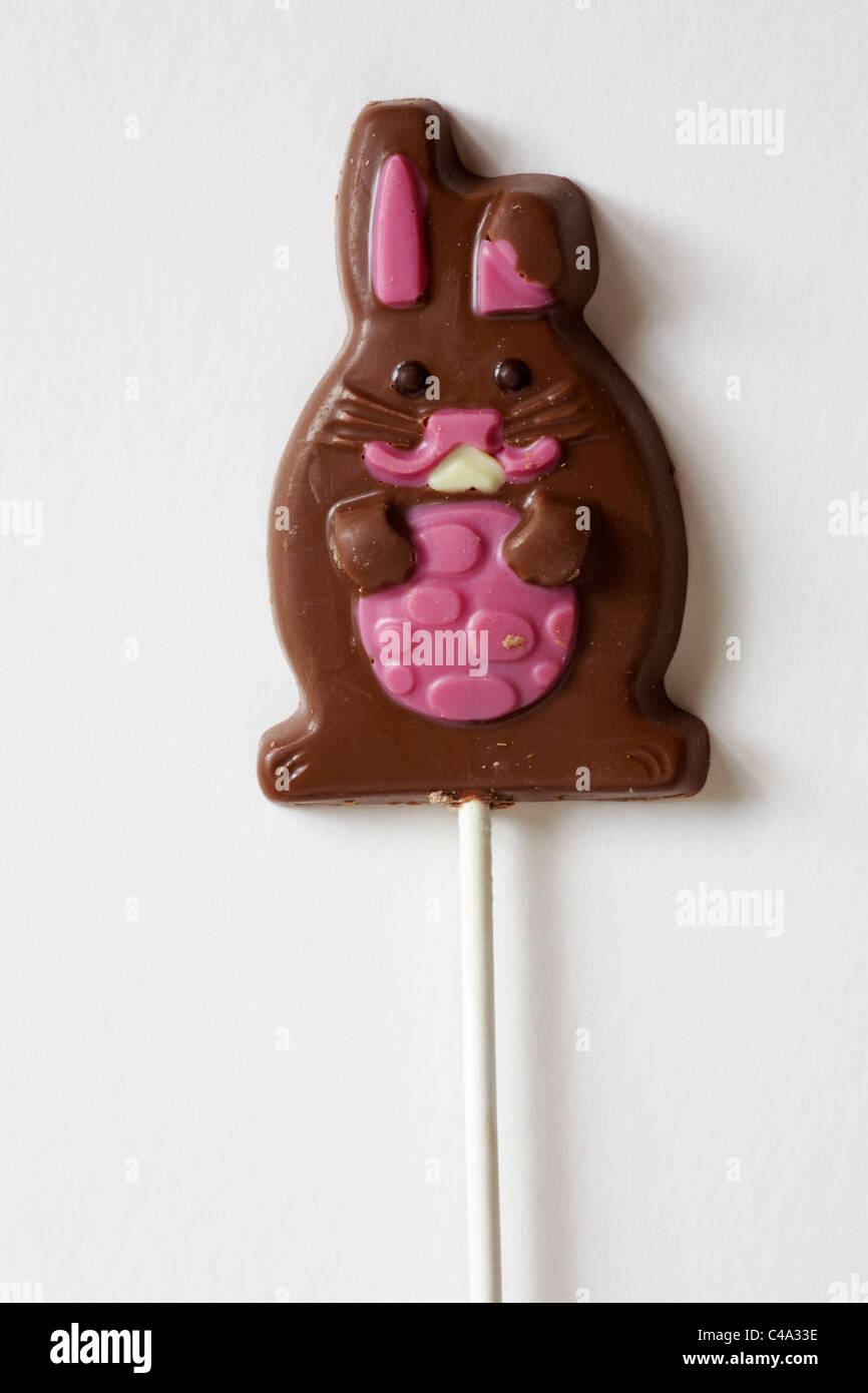 chocolate Easter rabbit carrying easter egg lolly lollipop isolated on white background - ready for Easter Stock Photo