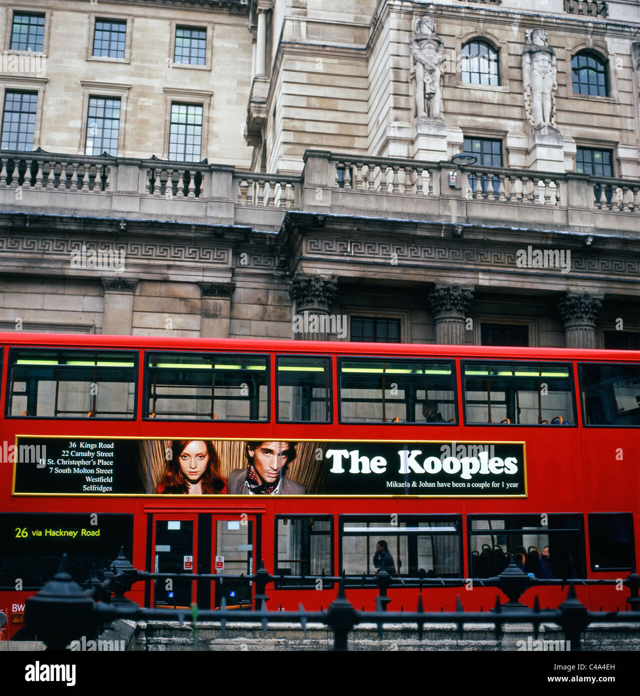 French fashion brand The Kooples advertising on the side of a red London bus in front of the Bank of England, London UK Stock Photo