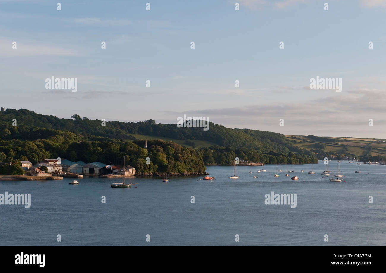 A peaceful summer evening view of the Rame Peninsula, Cornwall, seen from across the River Tamar (or the Hamoaze), looking towards St John's Lake Stock Photo