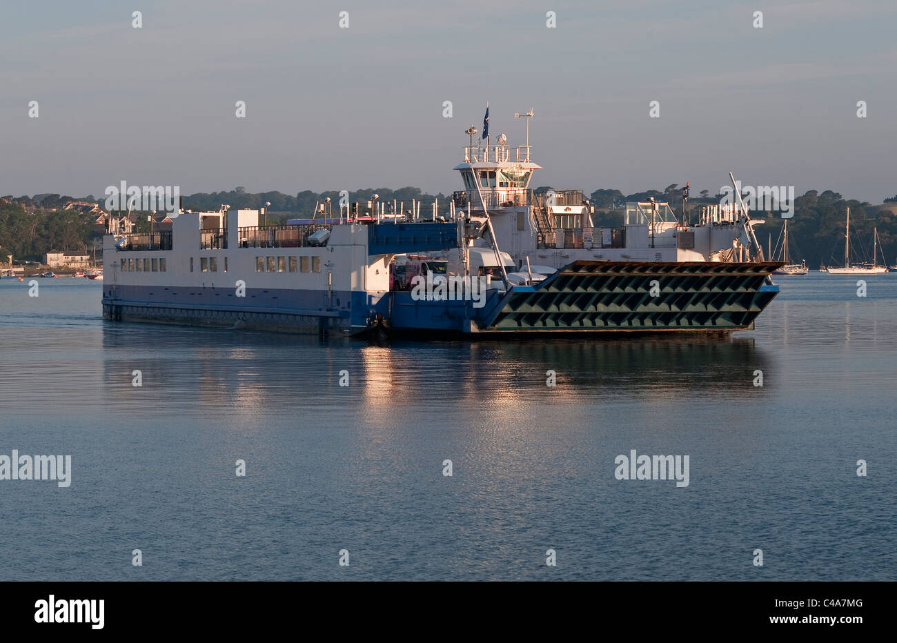 Early morning view of the Torpoint chain ferry (the Plym II) crossing the Hamoaze (part of the River Tamar) between Devonport (Plymouth) and Torpoint. Stock Photo
