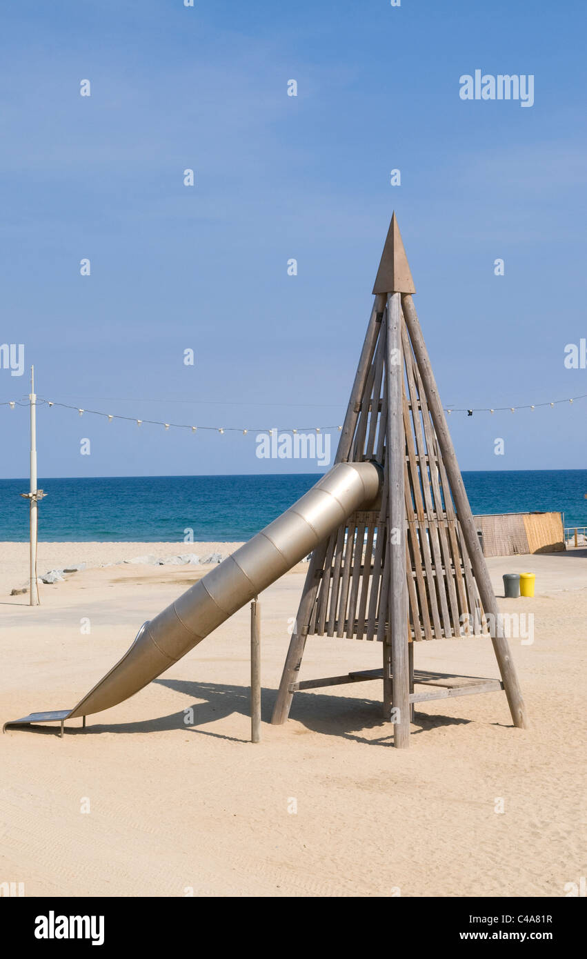 Funky playground slide on beach in Barcelona, Spain Stock Photo Alamy
