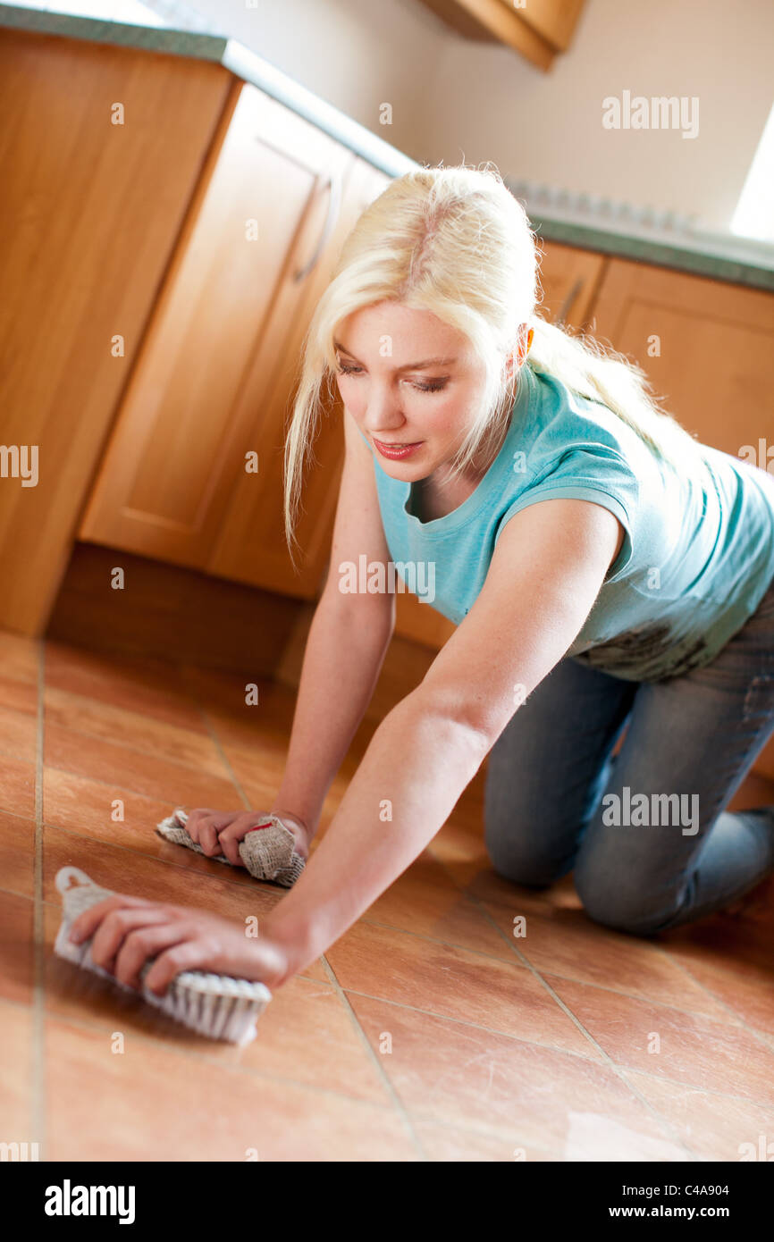 Woman scrubbing floor Stock Photo