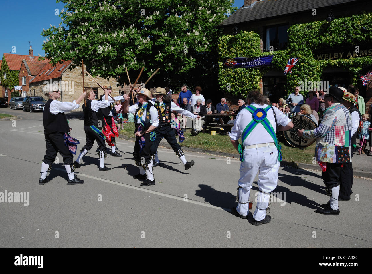 Morris dancers celebrating May Day outside the Welby Arms public house in Allington, Lincolnshire, England. Stock Photo