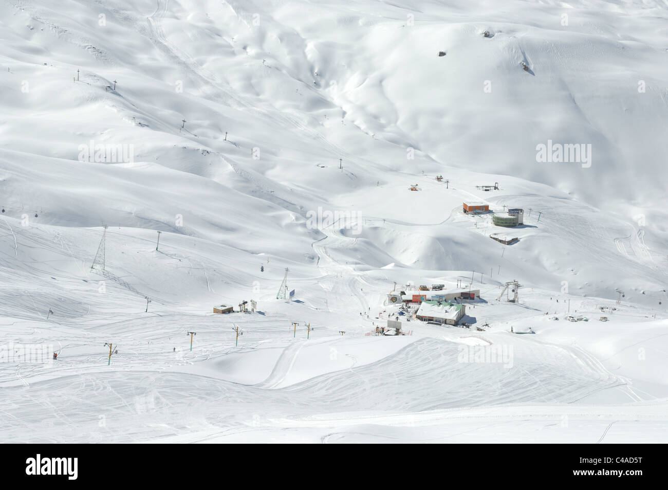 Dizin ski resort in the Alborz mountains of Iran under a blue sky and snowfall Stock Photo