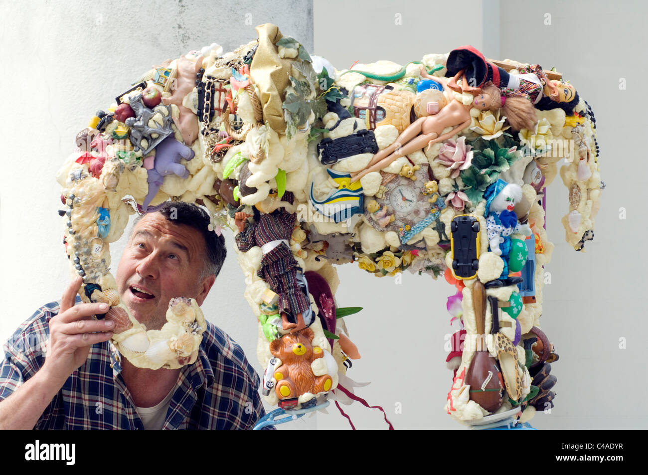 Sculptor Anthony Heywood and his sculpture 'Earth Elephant' made of recycled rubbish. Stock Photo