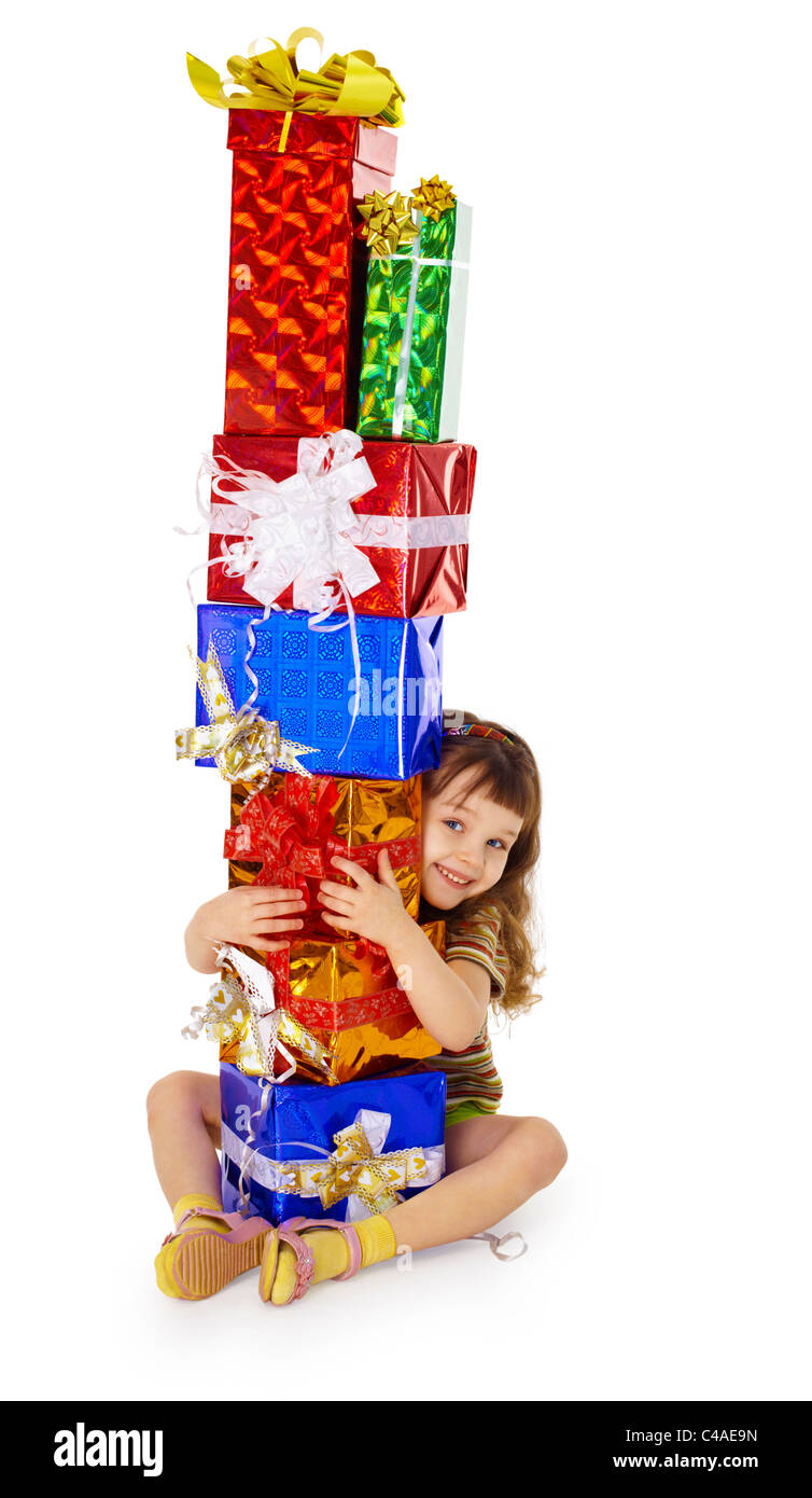 A little girl hugs birthday gifts, isolated on a white background Stock Photo