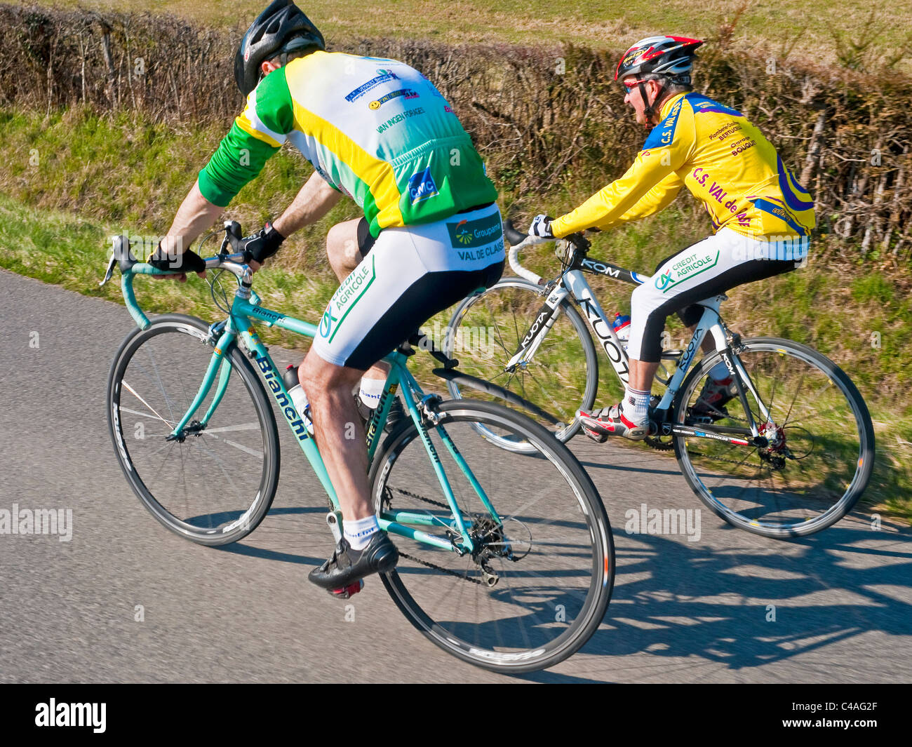 Two amateur sport cyclists training on road - France. Stock Photo