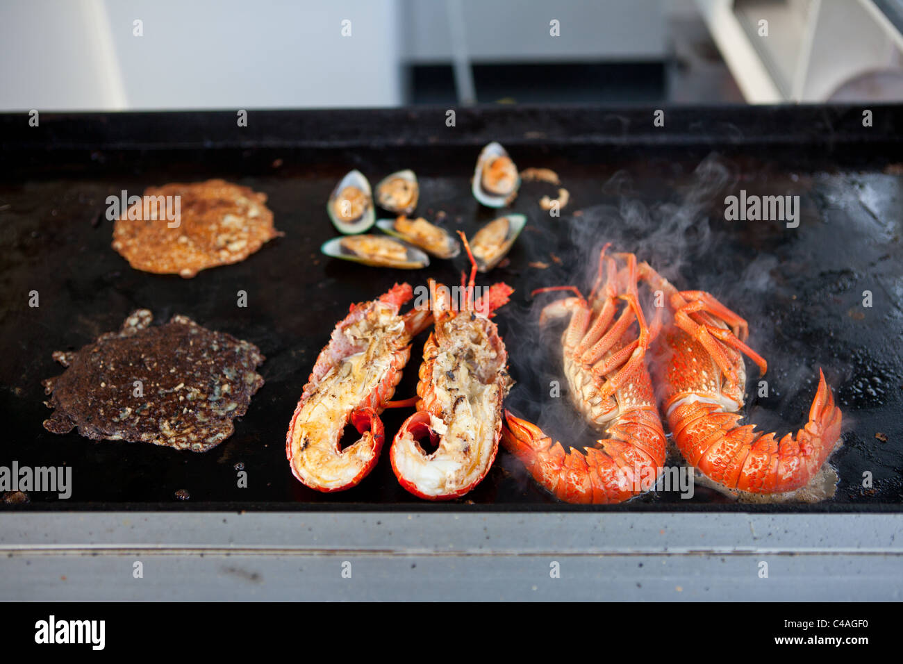 New Zealand lobster on grill in  a small gourmet restaurant in Kaikoura, New Zealand Stock Photo