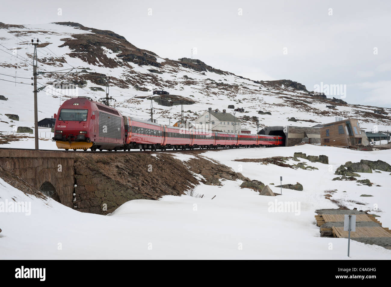 Electric train leaves Finse station for Bergen, southern Norway. Stock Photo