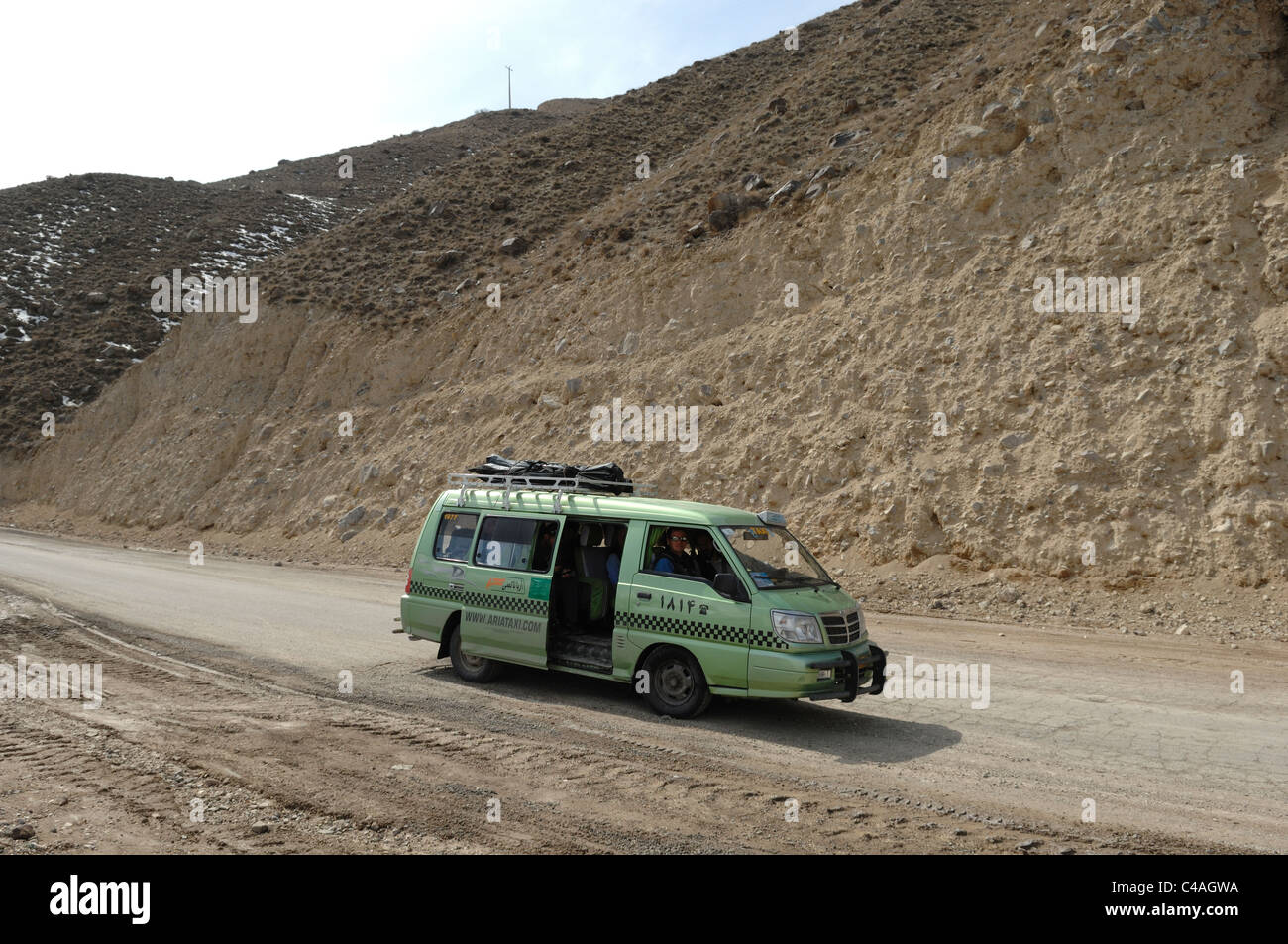 An Iranian people carrier taxi parked on a dirt road above Polor in the Alborz mountains Stock Photo
