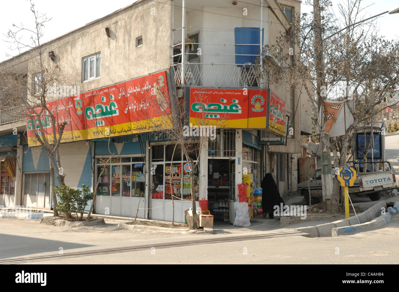 Shopping and retail grocery stores along the side of the road in Rudehen near Tehran in Iran Stock Photo