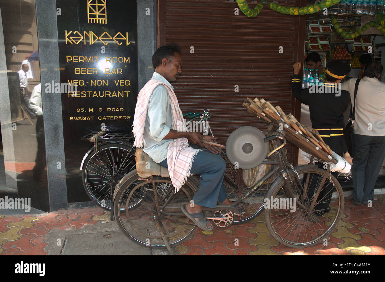 An Indian man sharpening knives on a cycle powered knife sharpener Stock  Photo - Alamy