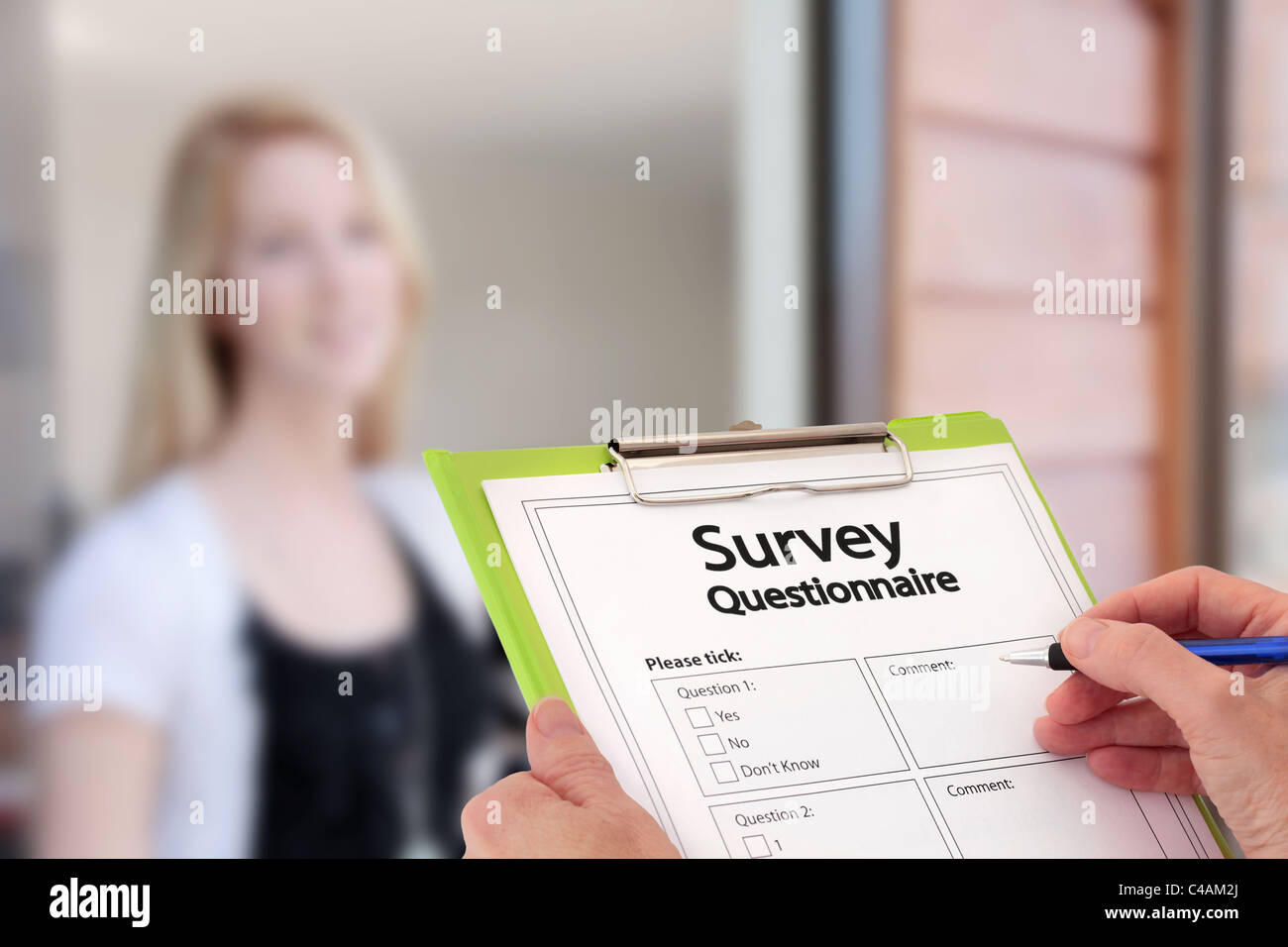 Girl Answering Market Research Survey Questionnaire at the Door Stock Photo