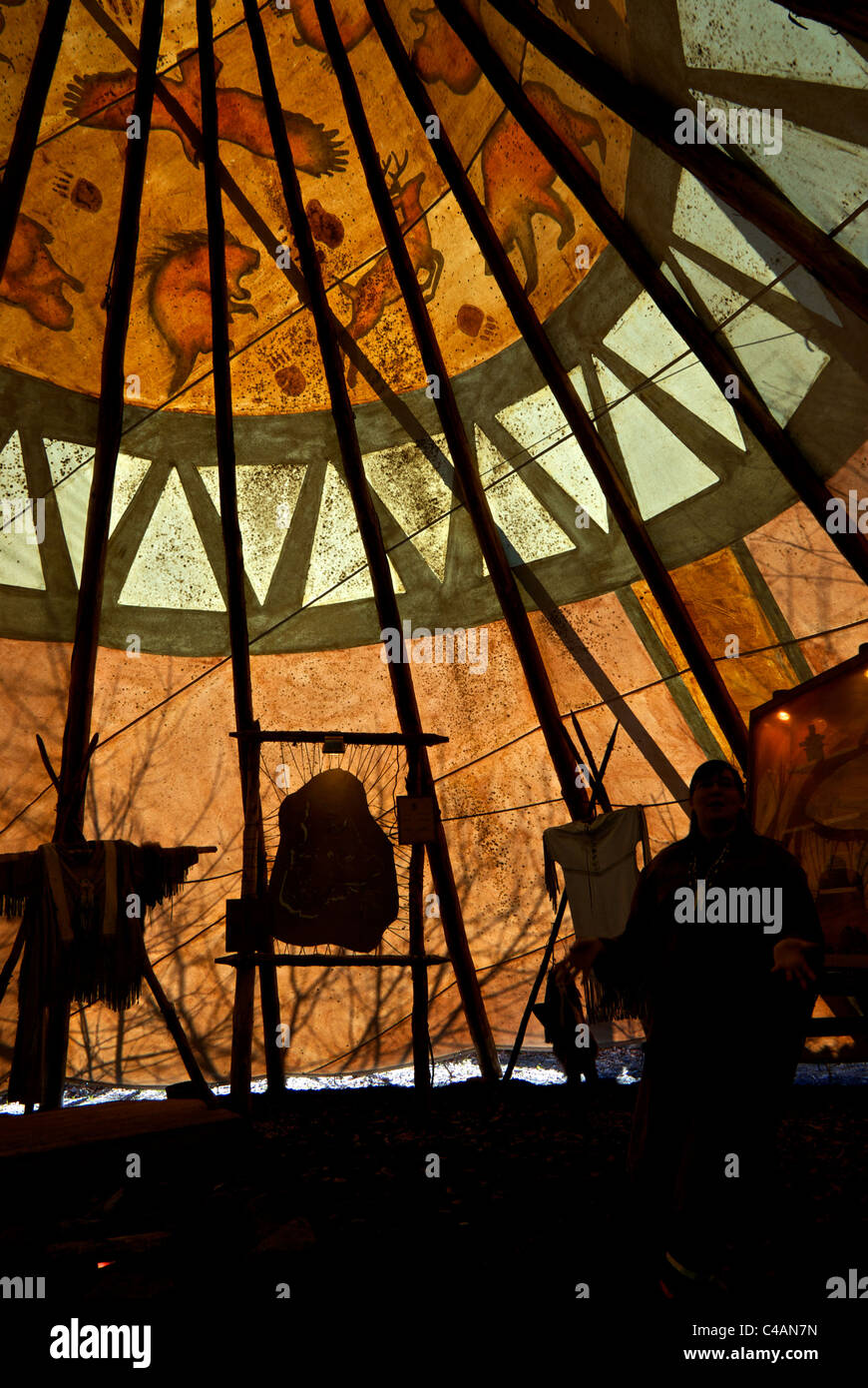 Tour guide in slhouette motion blur Huron First Nations tepee interior Wendake Quebec Stock Photo