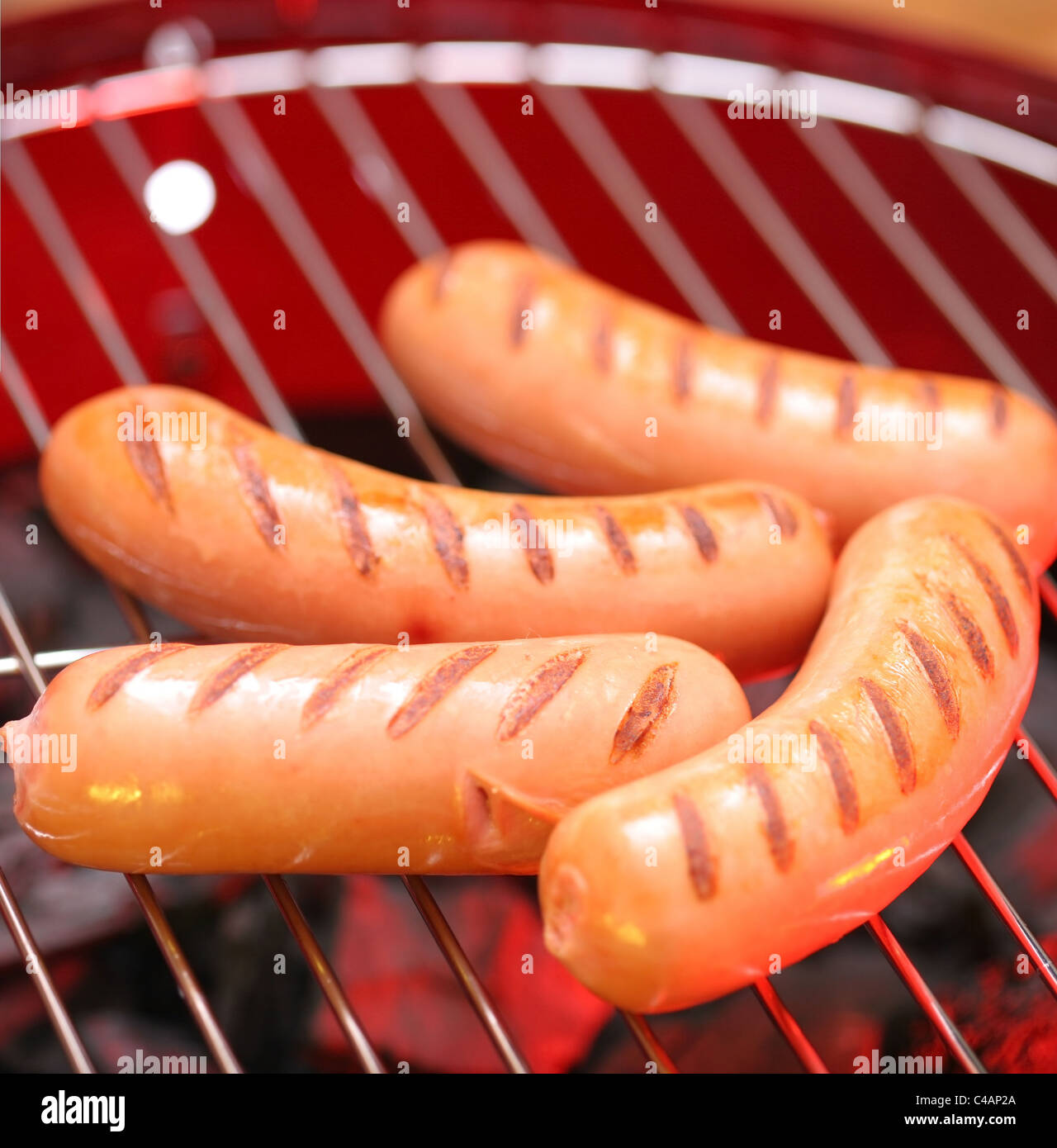 Hot sausages on barbecue Stock Photo