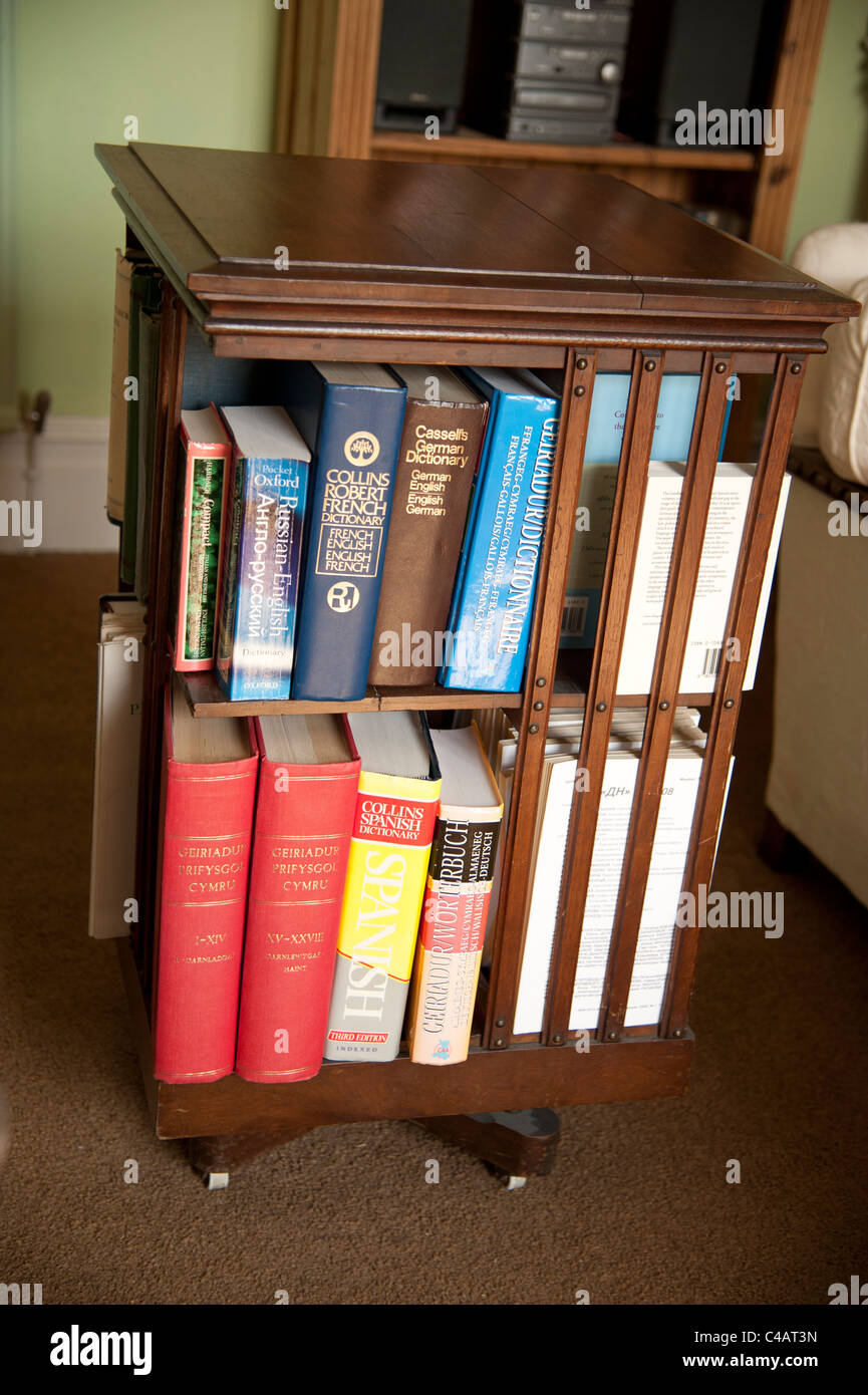 a small rotating carousel bookcase full of various dictionaries Stock Photo