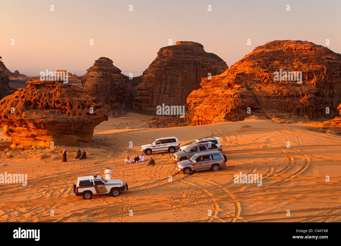 Saudi Arabia, Madinah, Al-Ula. Tourists enjoy 4WD excursions in the spectacular wadis and rugged hills that comprise the desert Stock Photo