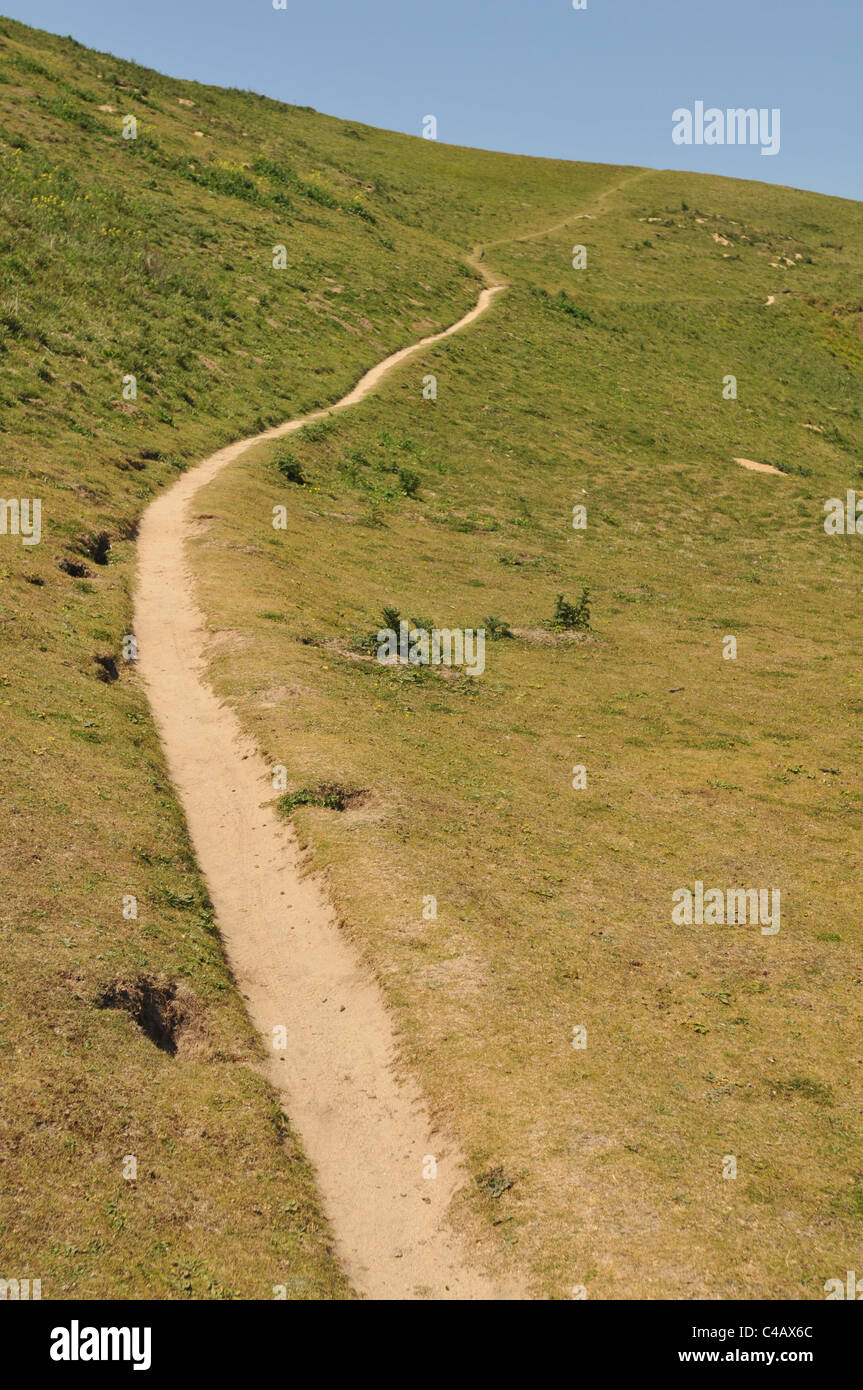 A path running up a hill at Crantock Bay, Cornwall Stock Photo