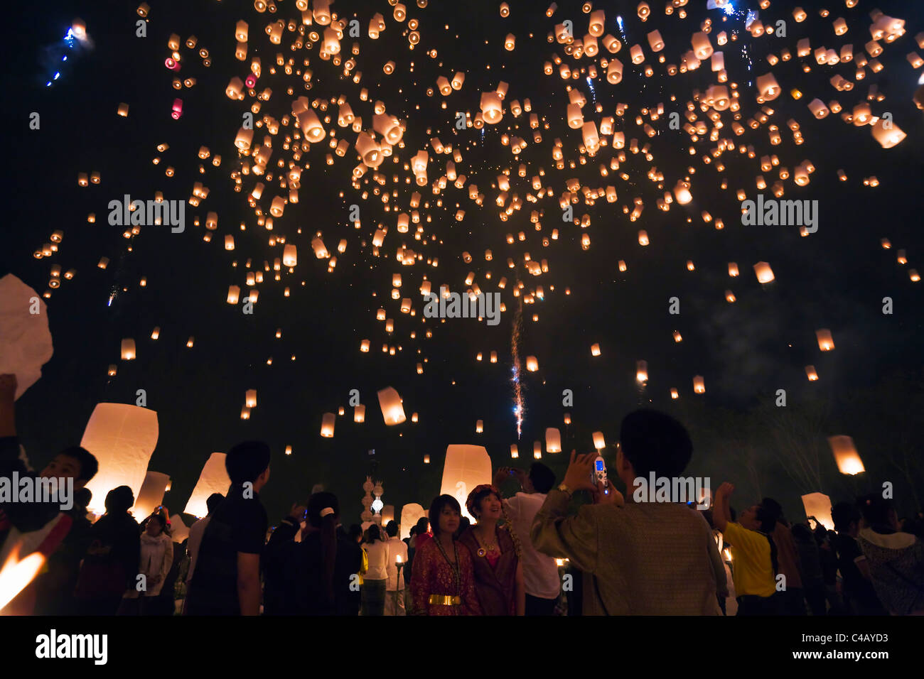Thailand, Chiang Mai, San Sai.  Revellers launch khom loi (sky lanterns) into the night sky during the Yi Peng festival. Stock Photo