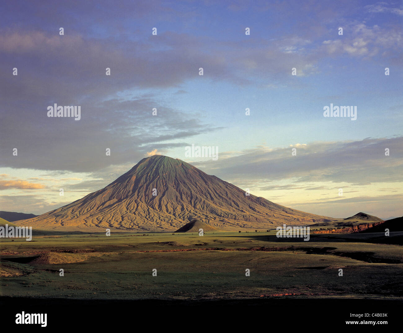 Ol doinyo Lengai, the Maasais Mountain of God, bathed in early morning sun.  It is the only active volcano in the Gregory Rift Stock Photo