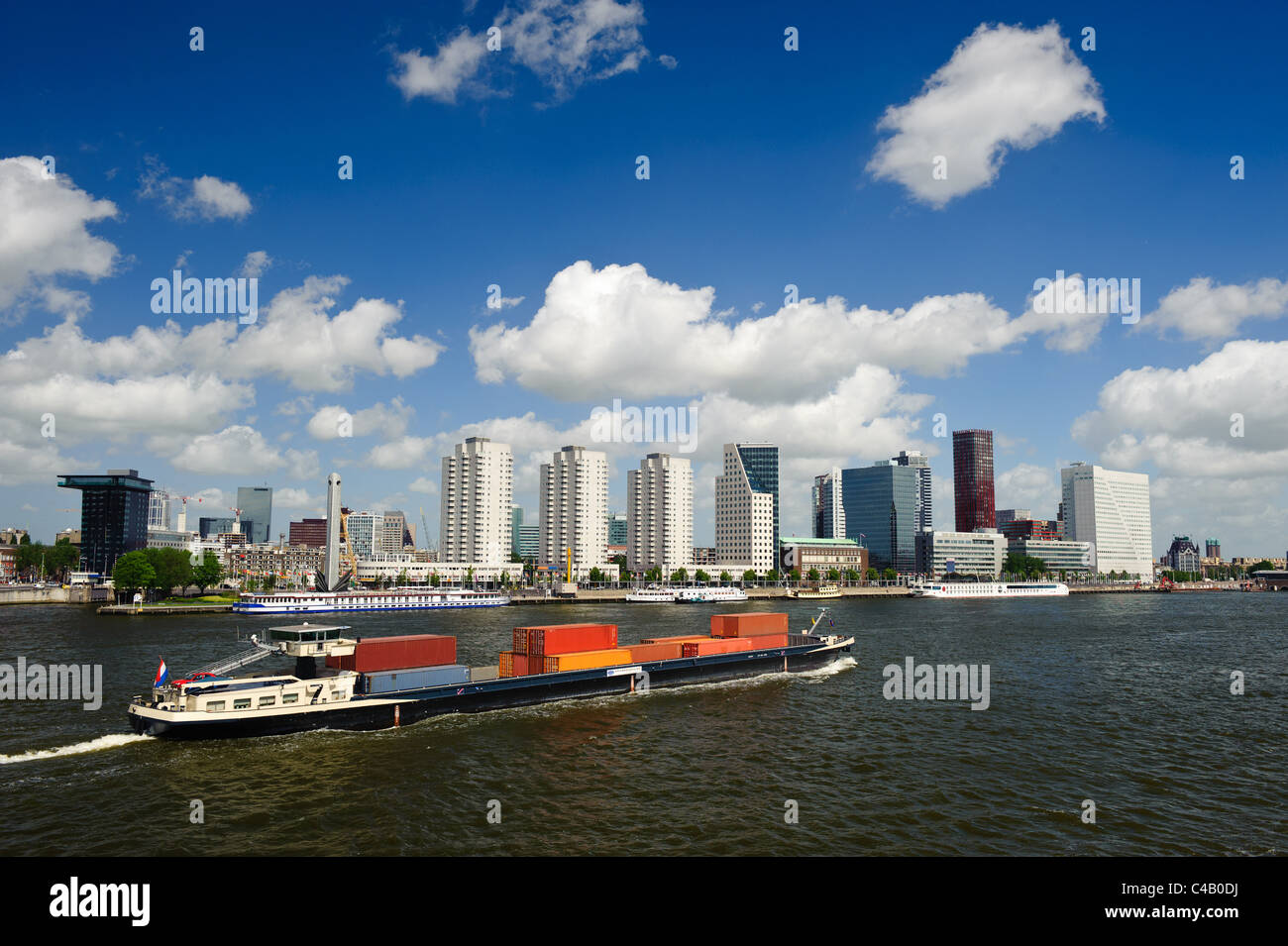 Rotterdam skyline and a container ship on the meuse river the Netherlands, Europe Stock Photo