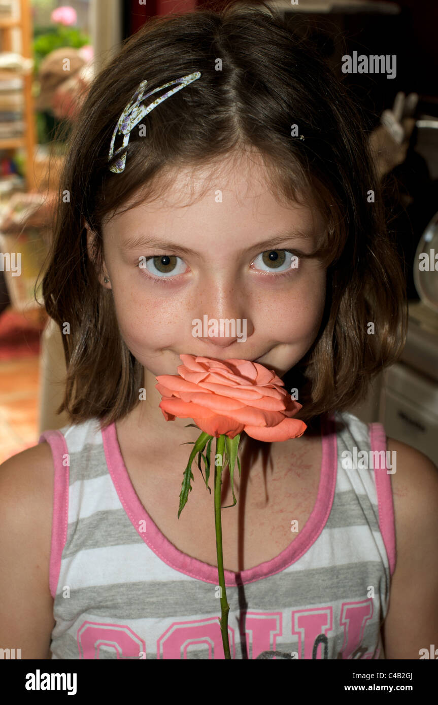 Young girl smelling a rose Stock Photo - Alamy