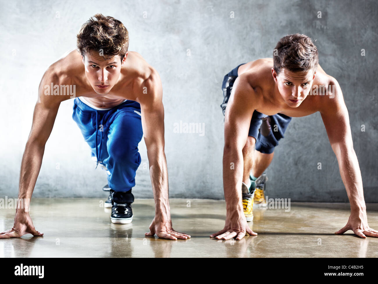 Two runners on start. Focus on face Stock Photo Alamy