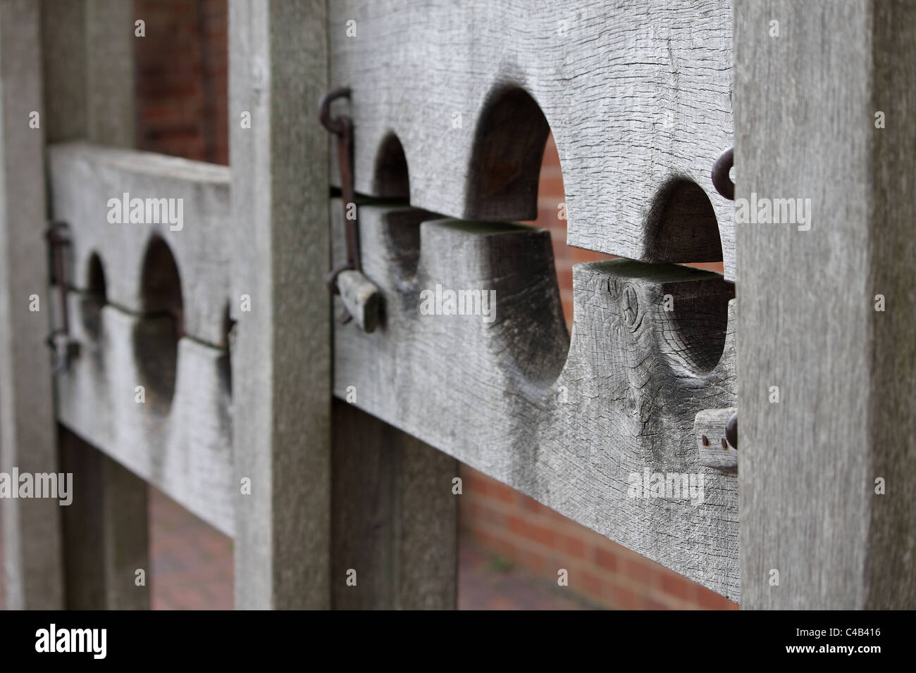 Medieval wooden stocks used for punishing crime and so people could throw vegetables and other rotten food at the punished. Stock Photo