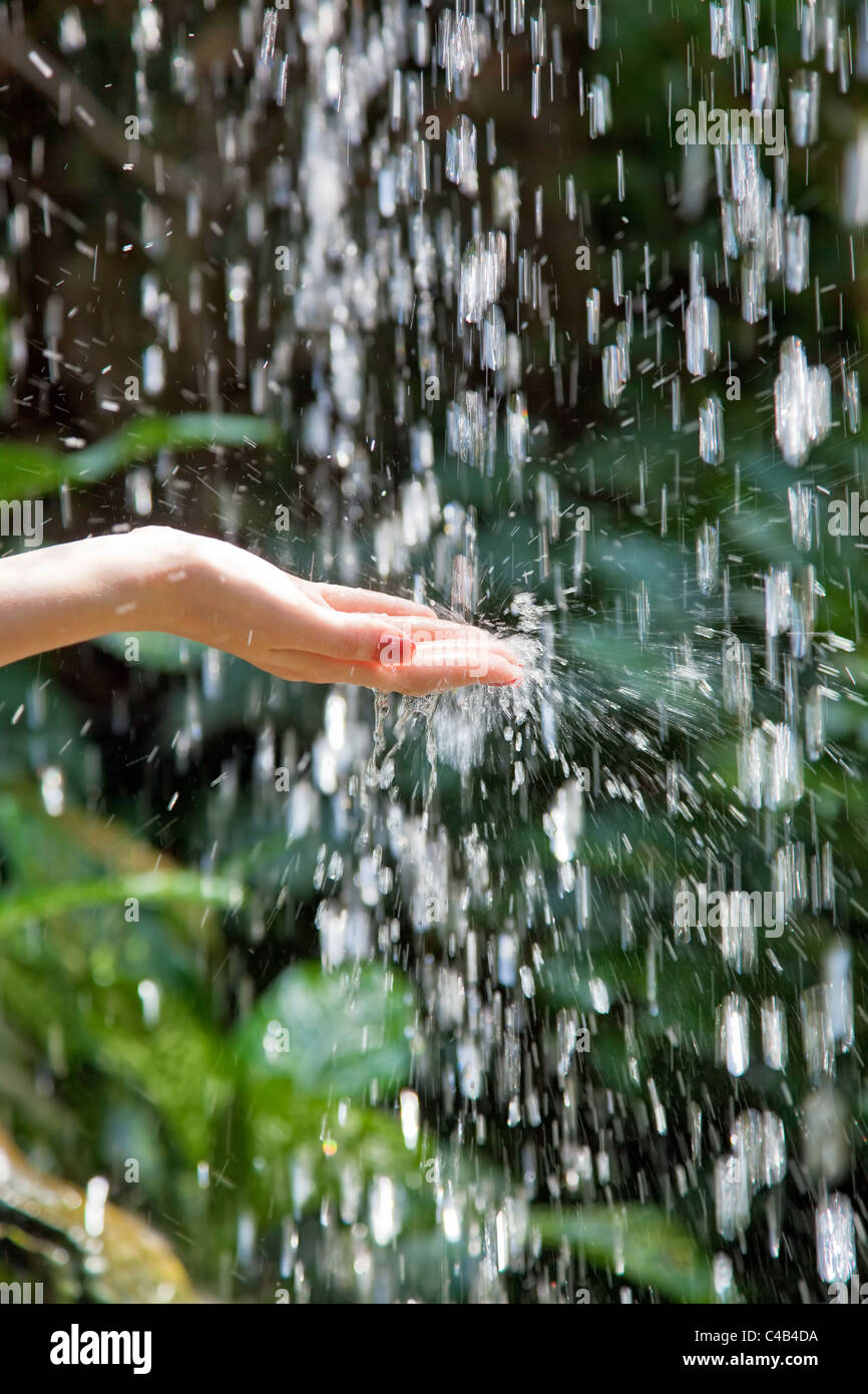 Woman hand with small waterfall. Stock Photo