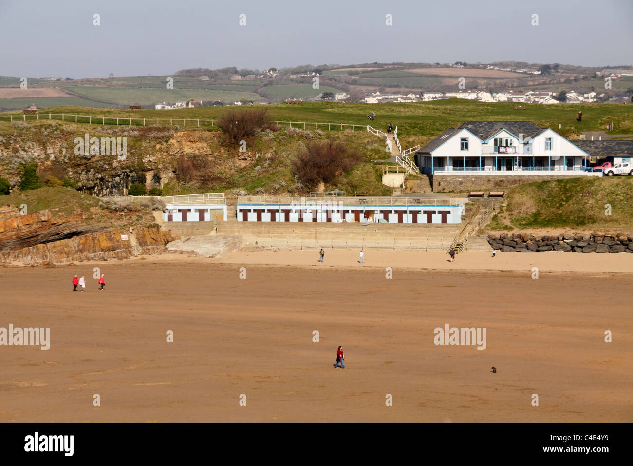 Bude, North Cornwall. Extensive beach with beach huts and a few people during out of season period. Stock Photo