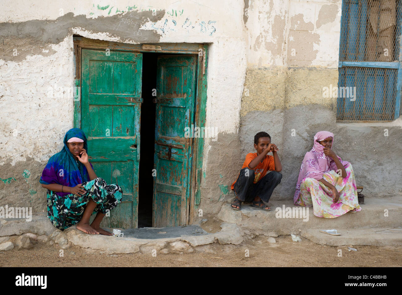 People sitting outside their house, Berbera, Somaliland, Somalia Stock Photo