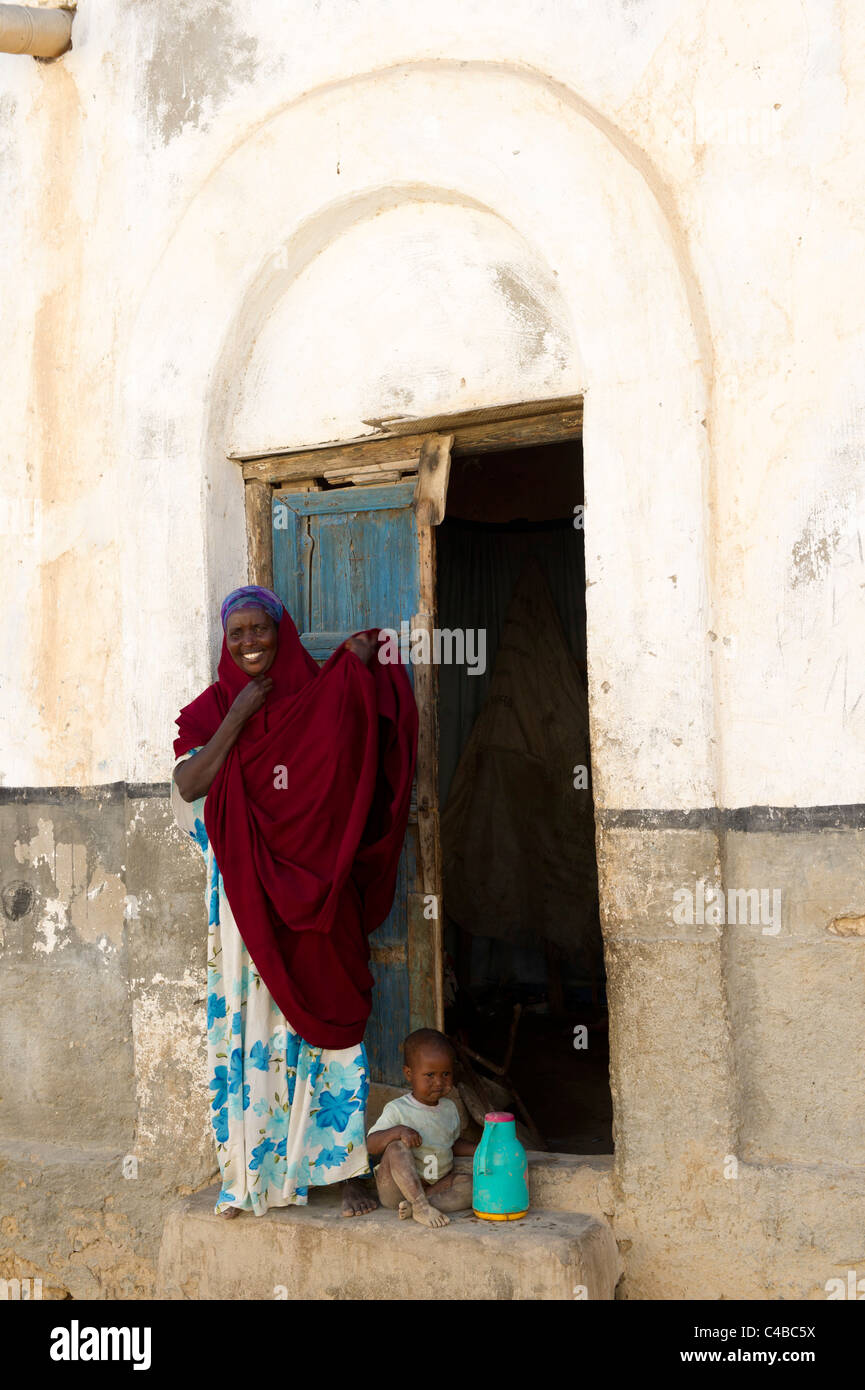 Woman with child outside her house, Berbera, Somaliland, Somalia Stock Photo