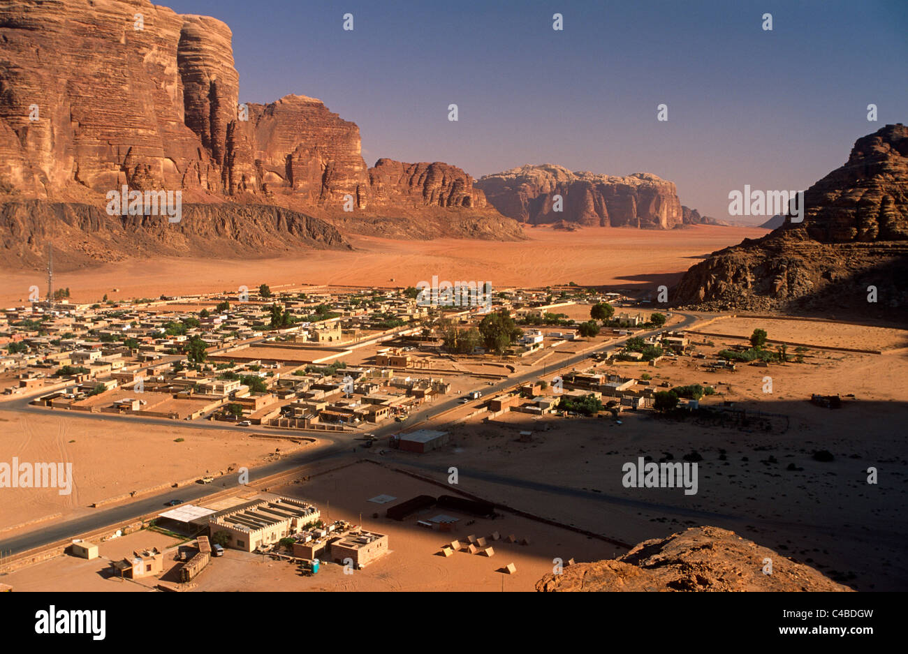 Jordan; Wadi Rum. Spectacular cliffs frame the Bedouin village of Rum,  through which most tourists pass when visiting Wadi Rum Stock Photo - Alamy