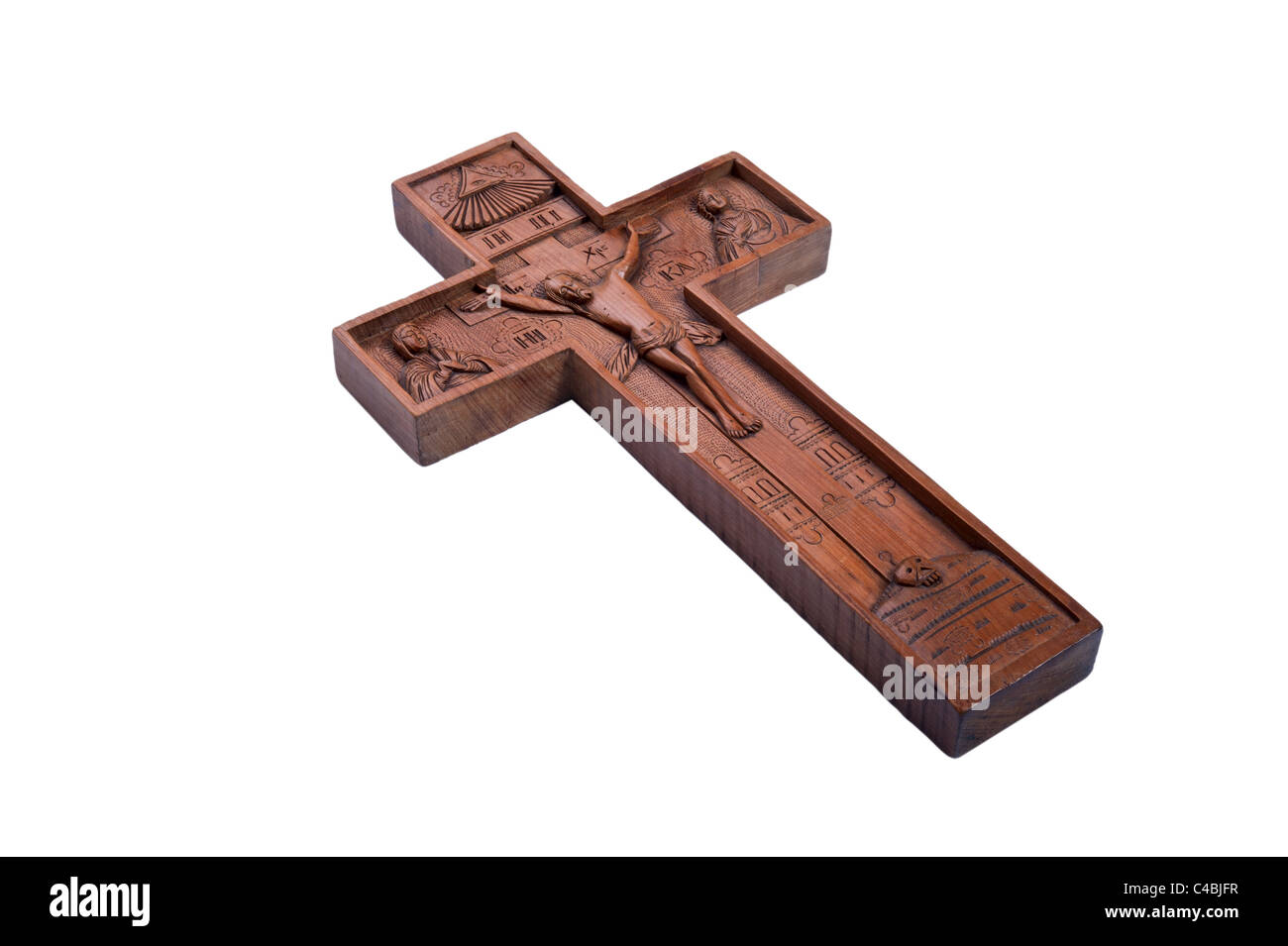 Wooden carving of Jesus on cross; isolated on white background Stock Photo
