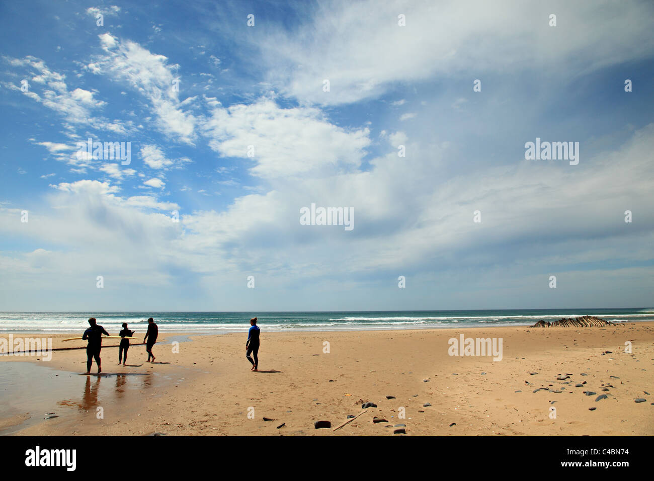 Surferes walking on the Cordama beach Costa Vicentina West coast of Algarve Portugal Stock Photo