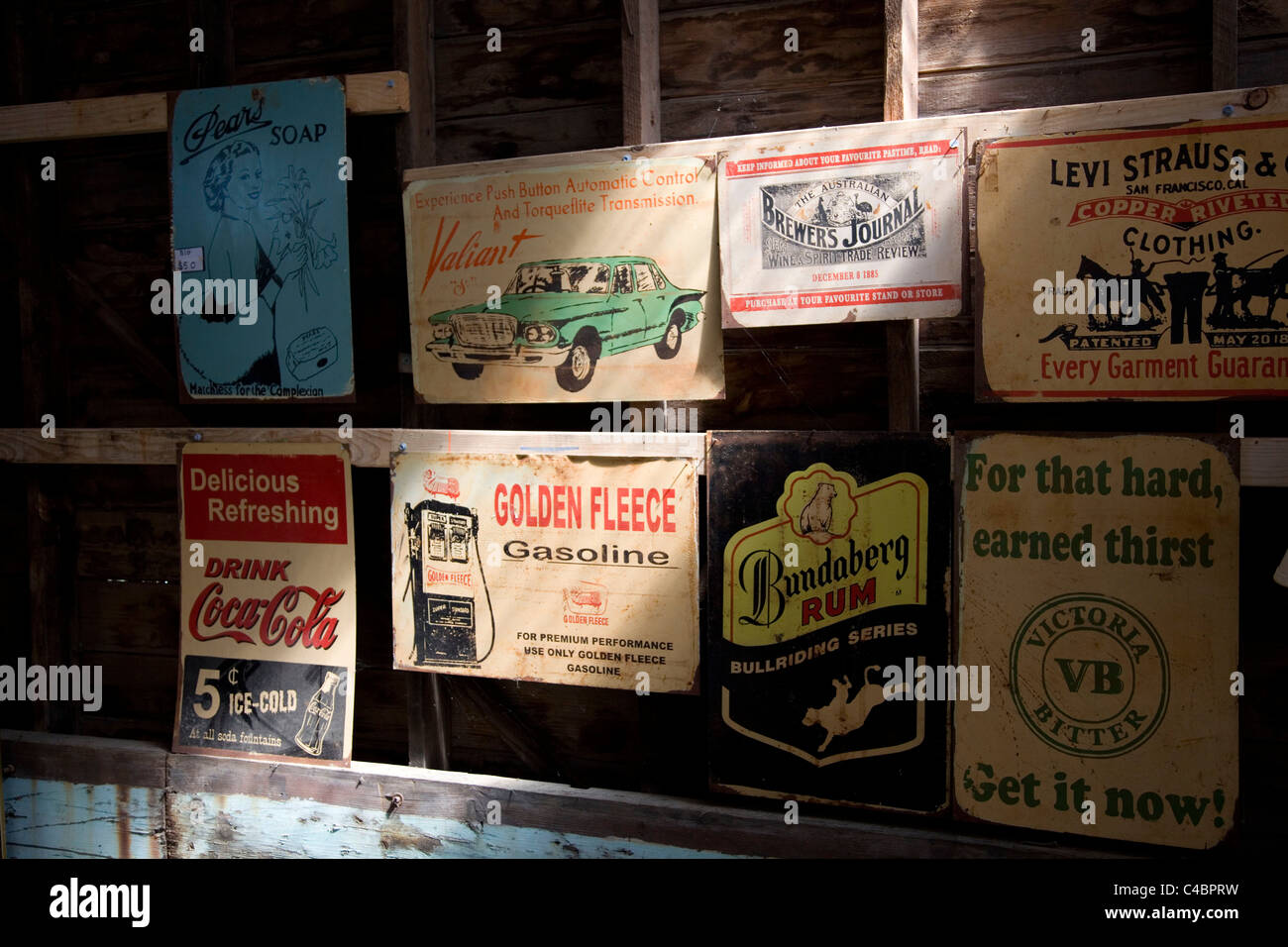 Old Australian advertising signs for sale in a junk shop in Maldon. Stock Photo