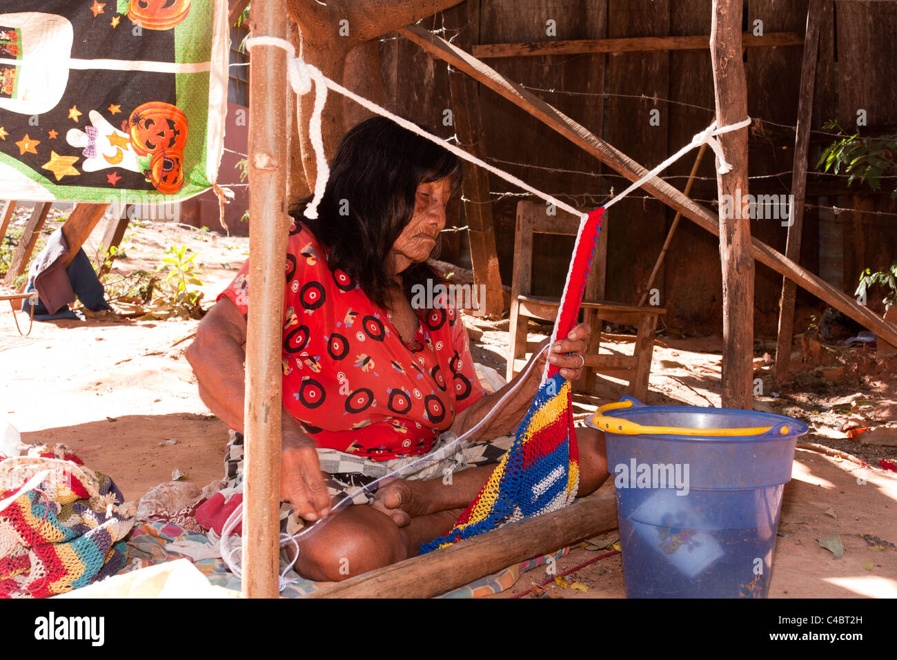 Maka tribe old woman making a handcraft, Maka tribe indigenous village on the outskirts of Asuncion, Paraguay Stock Photo
